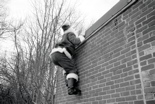 Santa scaling a wall